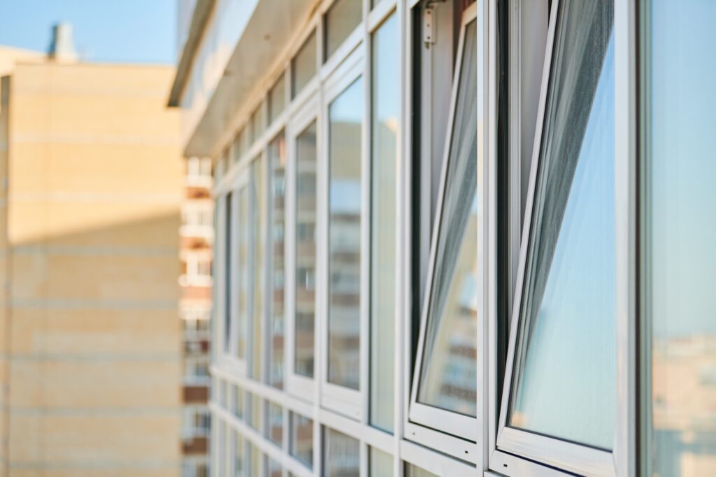 PVC windows on facade of skyscraper. Plastic double glazed windows. Building exterior.